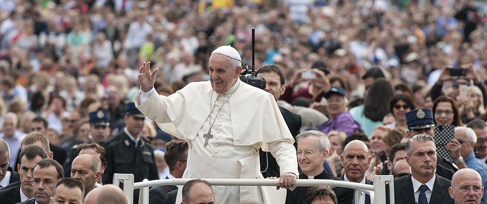 Pope Francis waves to crowd from popemobile