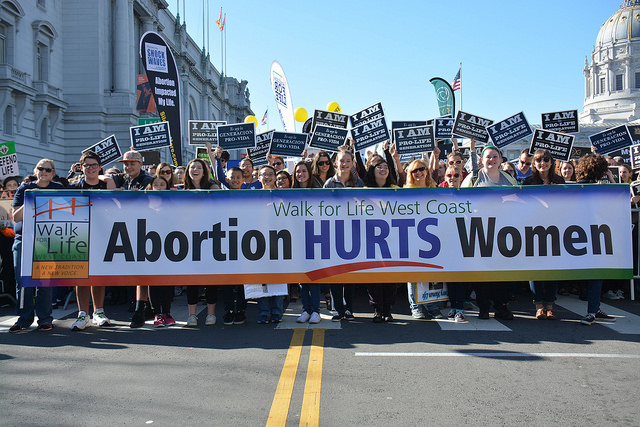 Walk for Life West Coast march with banner 'Abortion Hurts Women'