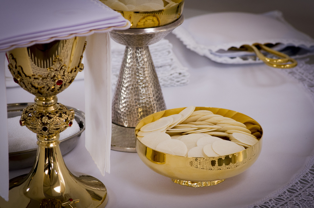 chalice and Holy Eucharist on the altar during mass