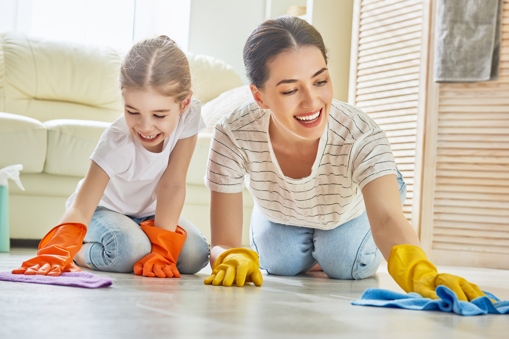 mother and daughter happily scrubbing floors