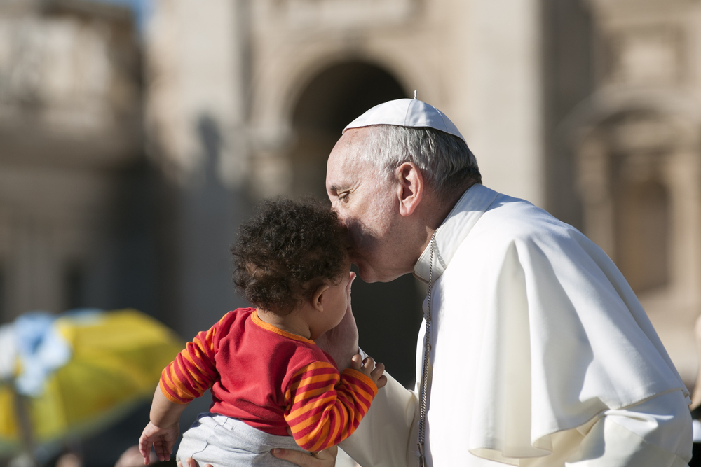 Pope Francis kisses baby's head