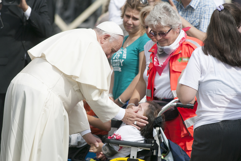 Pope Francis greets disabled person