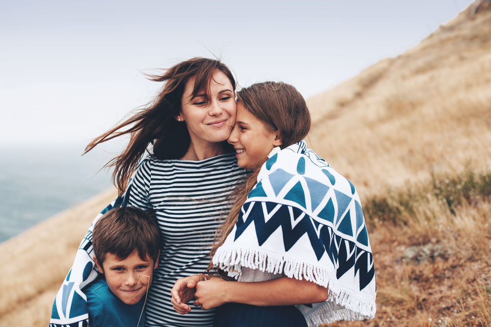 mom walks with two preteen kids