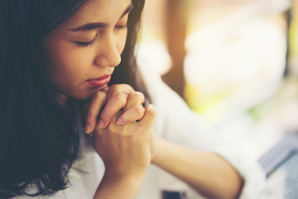 young woman prays