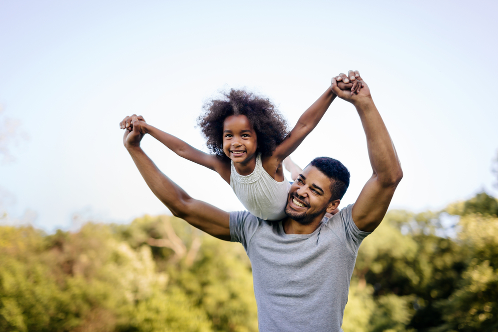Dad lifting daughter up in the air