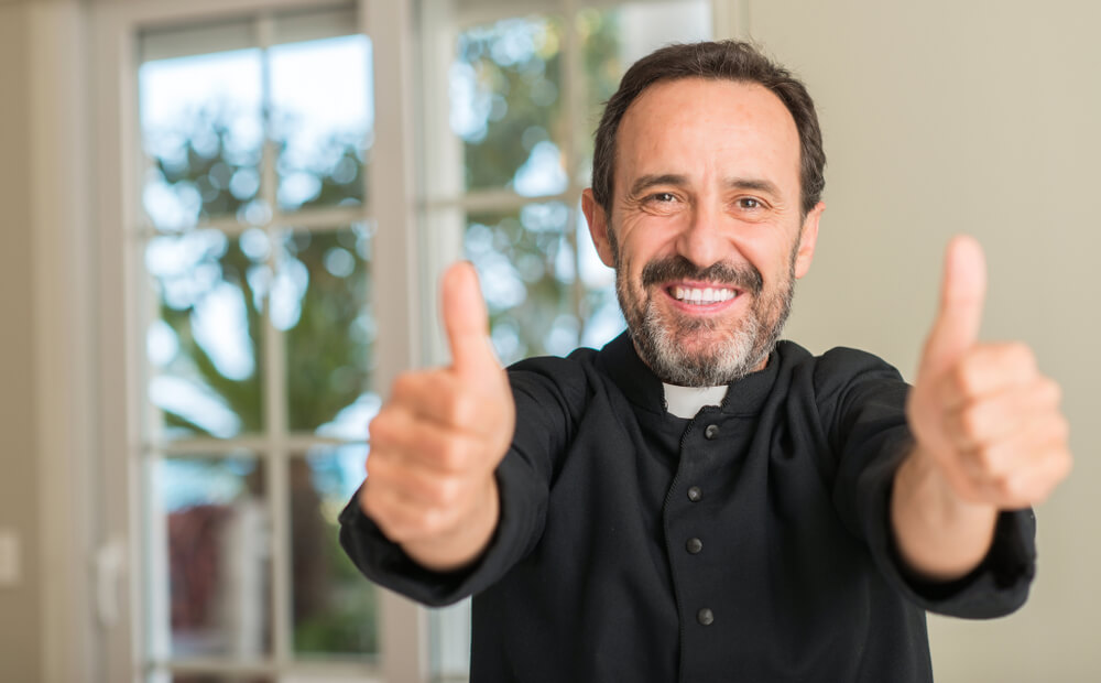Catholic priest gives thumbs up