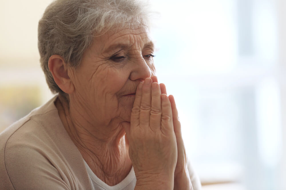 Older woman praying