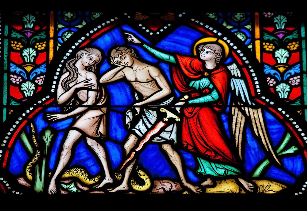 Stained glass of Adam and Eve being dispelled from the Garden of Eden