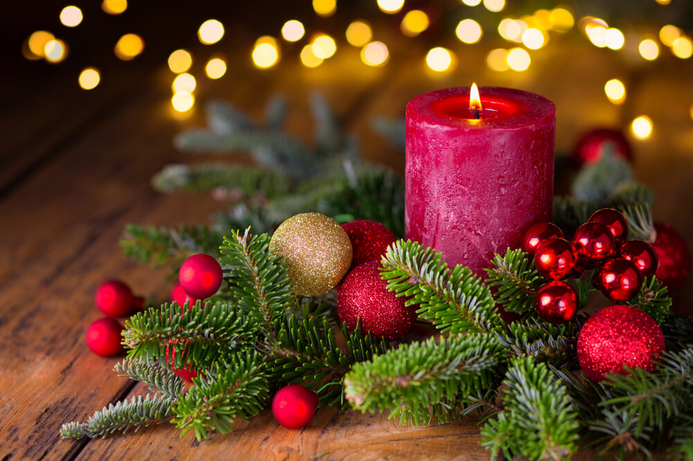 red candle with evergreen wreath