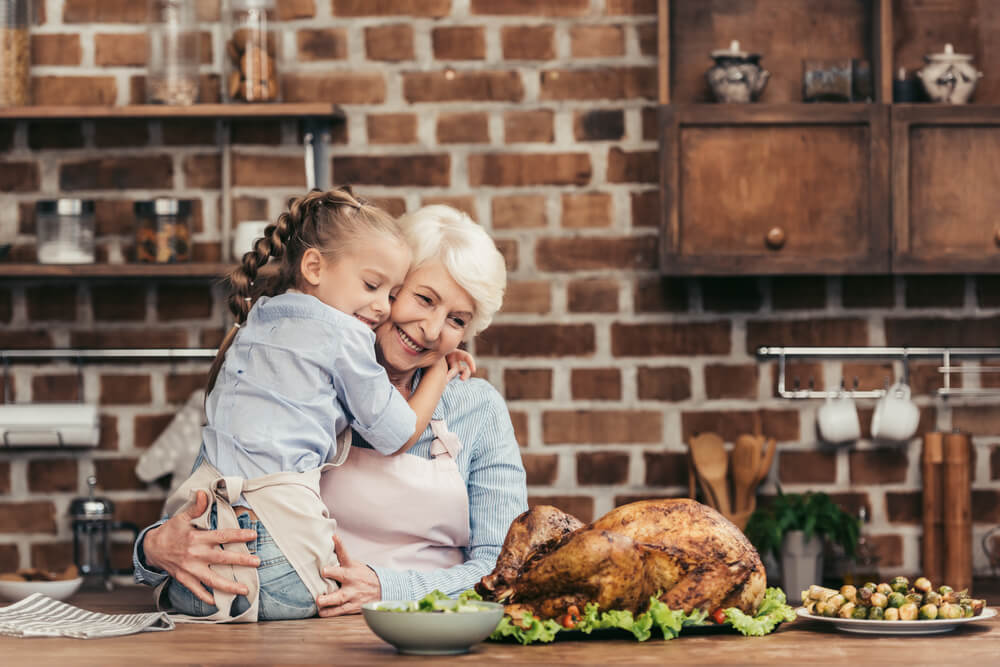 grandma and granddaughter make turkey for Thanksgiving