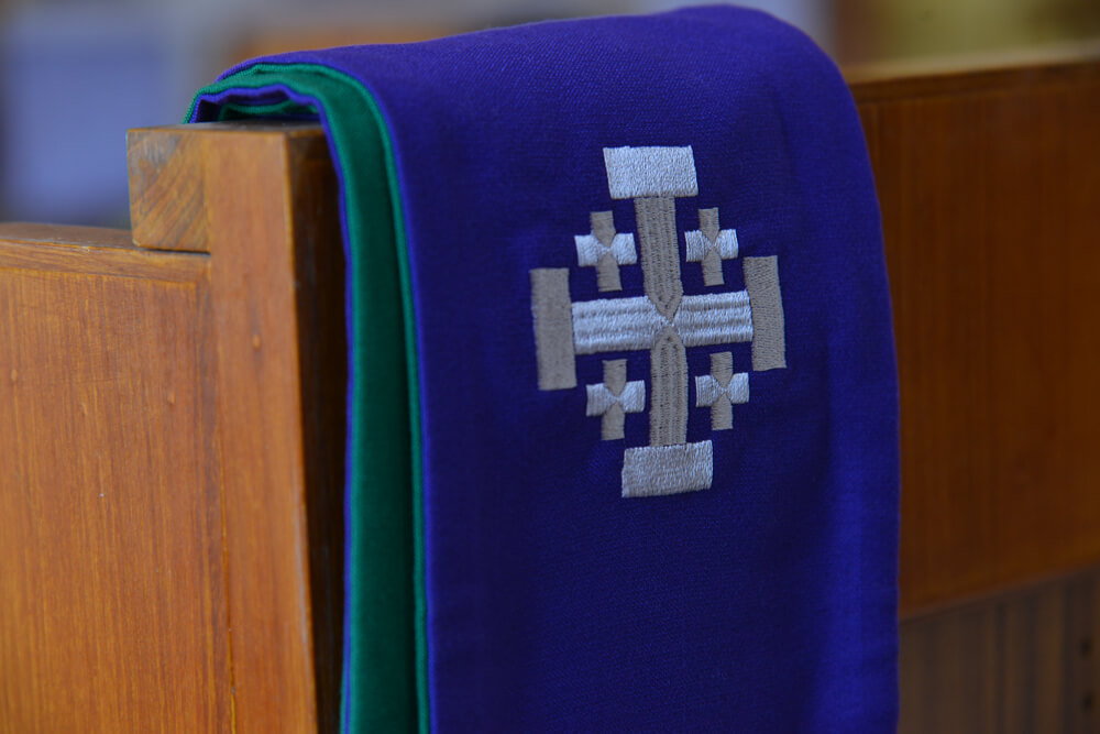 purple stole hanging on church pew