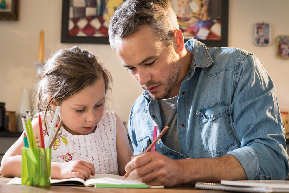 Dad helps daughter with homework