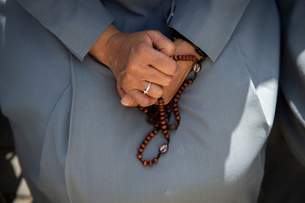 Nun prays the Rosary