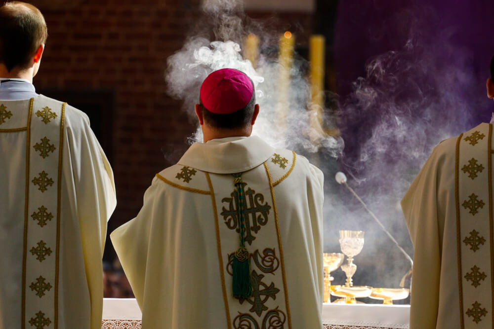 Bishop incenses the altar at Mass