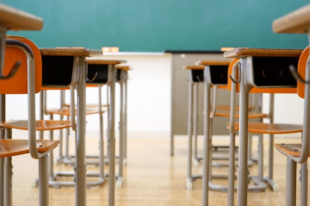 Empty schools, rows of desks in classroom