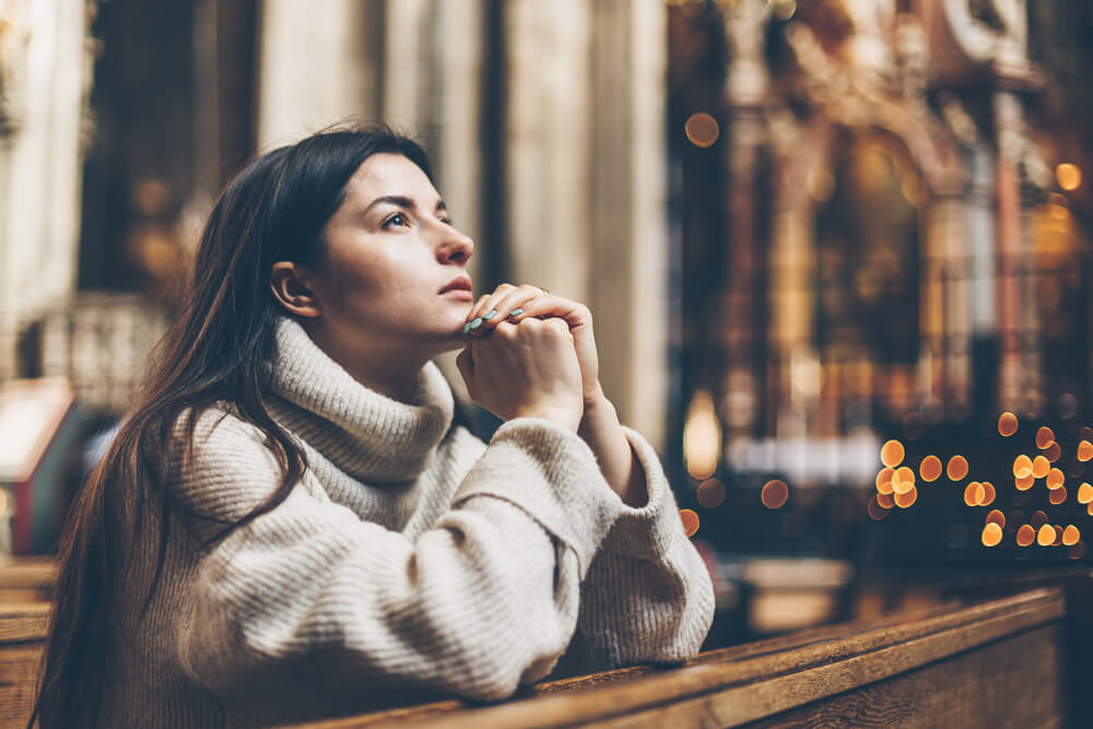Laity, woman prays at church