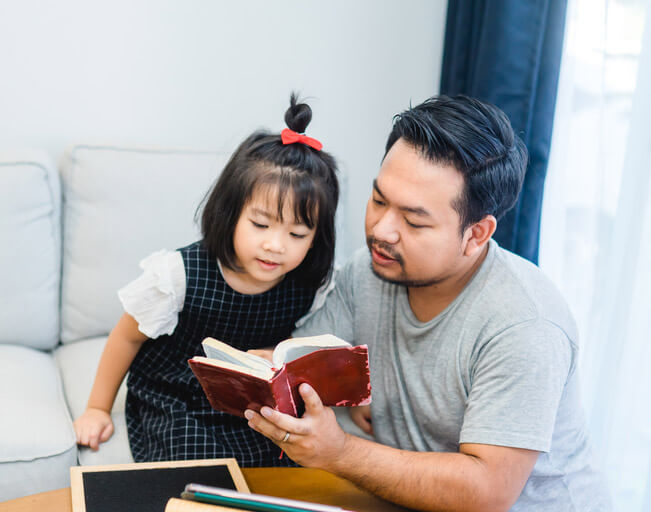 Dad and daughter study scripture