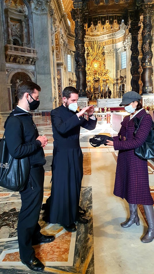 Priest blesses Sts. Peter and Paul medals at St. Peter's Basilica in Rome
