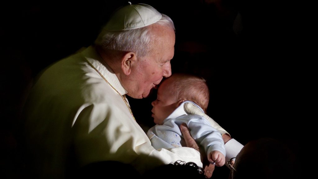 Pope St. John Paul kissing a baby